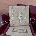 Gucci key pendant necklace with heart and G charm, silver-tone chain