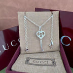 Gucci key pendant necklace with heart and G charm, silver-tone chain
