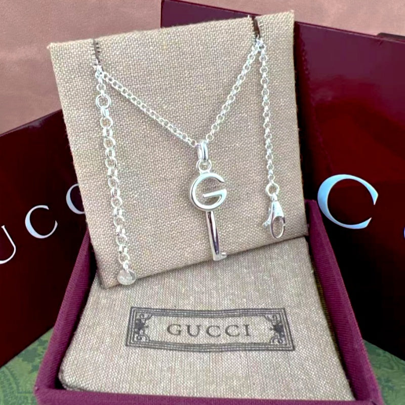Gucci G and key pendant necklaces on box, silver-tone chains with small dangle