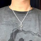 Silver-tone pendant necklace on model with G charm and key drop