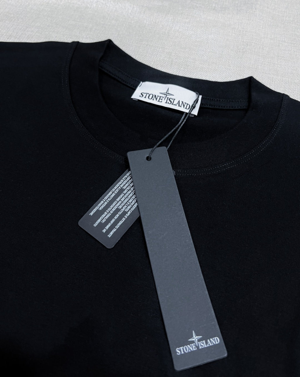 Black Stone Island T-shirt with neck label and hanging tags