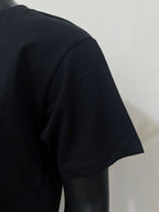 Black T-shirt with short sleeves, angled side view