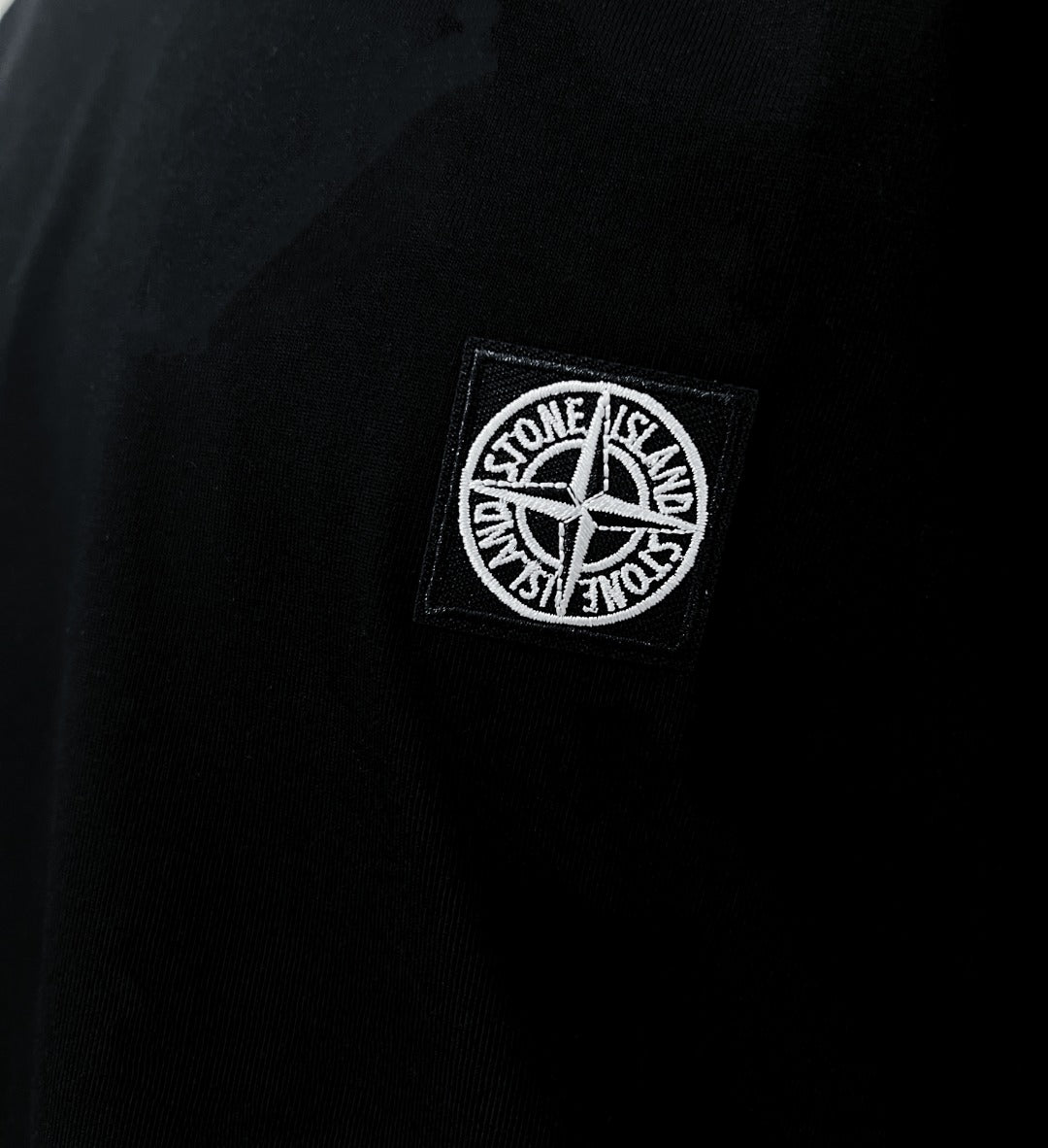 Stone Island logo patch on black T-shirt chest