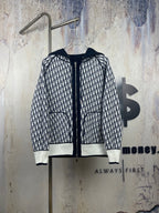 Black-and-white patterned zip-up hooded jacket with drawstring hood