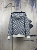 Black-and-white patterned zip-up hooded jacket, back view