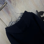 Navy zip-up hooded jacket with black-and-white patterned interior detail