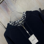 Navy zip-up hooded jacket with black-and-white printed interior and zipper