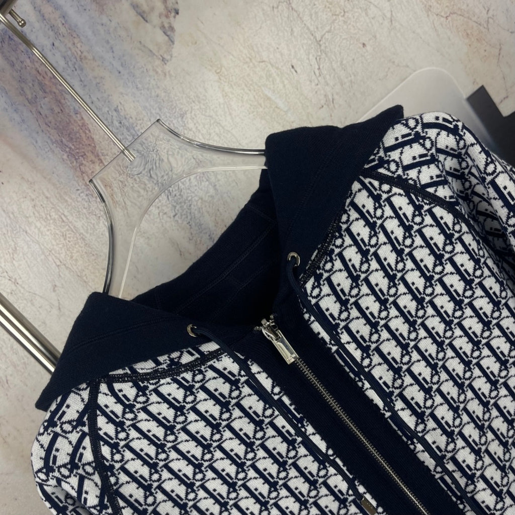 Navy zip-up hooded jacket with black-and-white patterned front panels