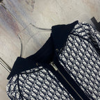 Navy zip-up hooded jacket with black-and-white patterned front panels