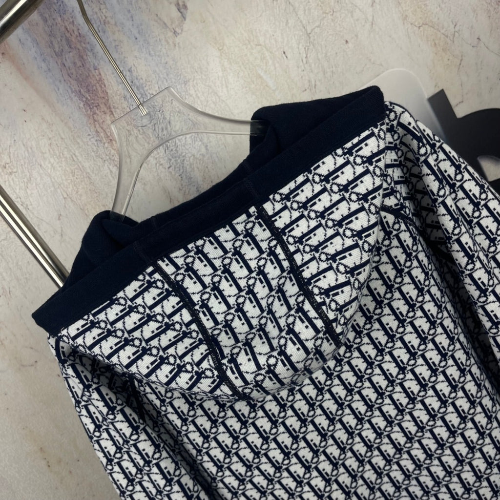 Navy zip-up hooded jacket with black-and-white monogram-pattern front and sleeves