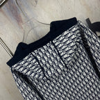 Navy zip-up hooded jacket with black-and-white monogram-pattern front and sleeves