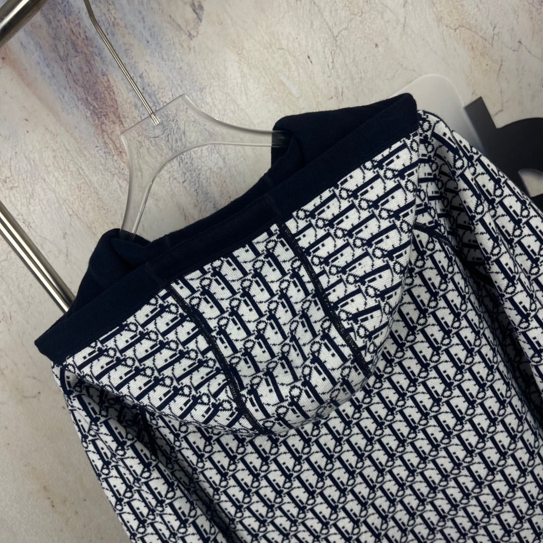 Navy zip-up hooded jacket with black-and-white monogram-pattern front and sleeves