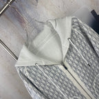 Dior long hoodie detail showing patterned inner lining and off-white front zipper