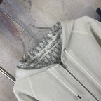 Dior zip hoodie front close-up with hood lining and patterned interior