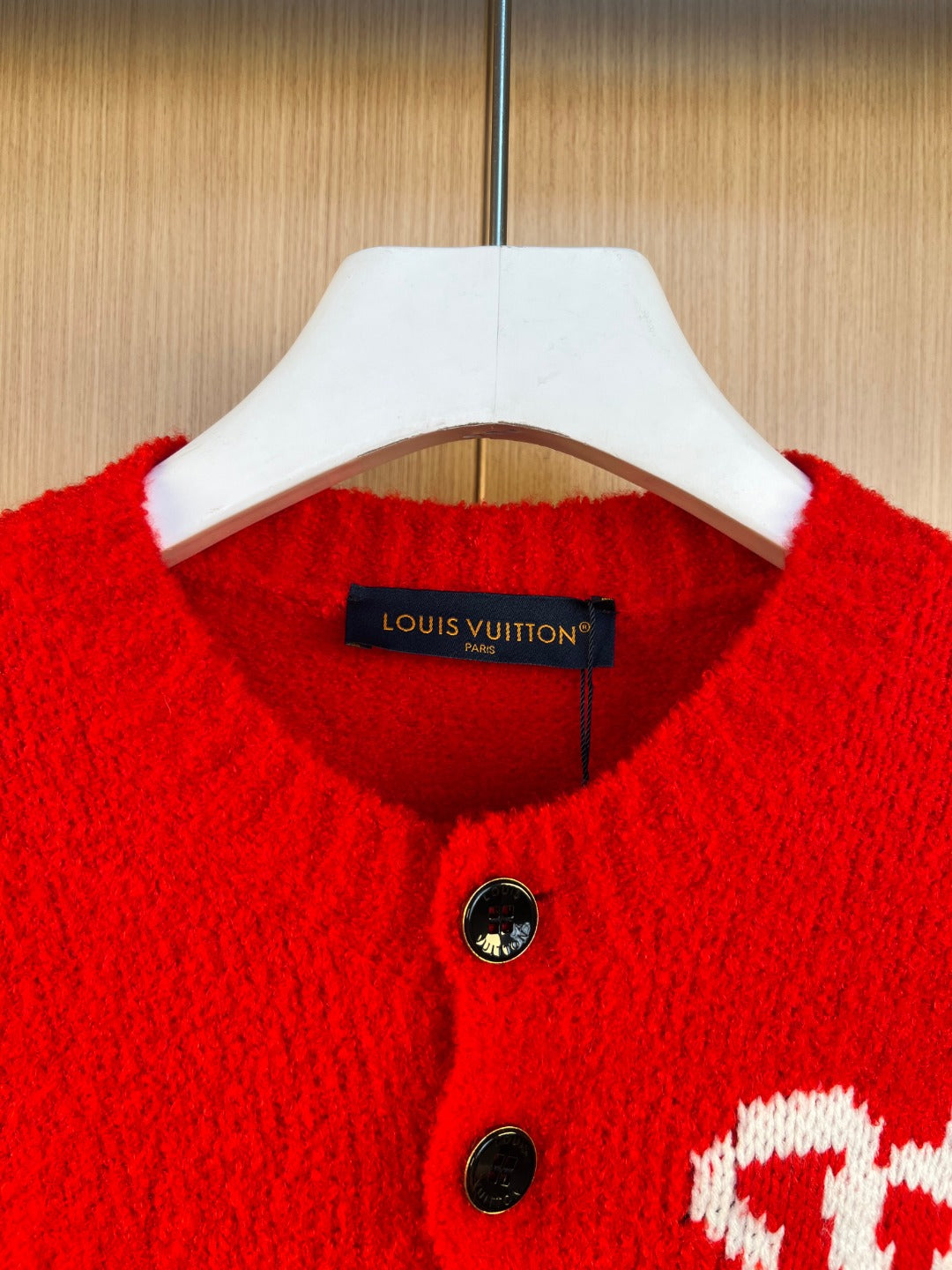 Red knit cardigan neckline with button placket and interior brand tag