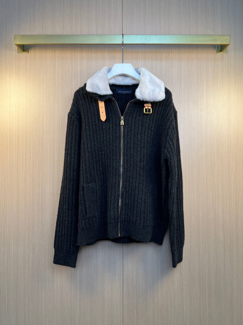 Dark knit jacket with faux fur collar, front zipper, and gold-tone logo hardware