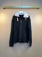 Dark knit jacket with faux fur collar, front zipper, and gold-tone logo hardware