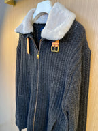 Dark knit jacket with faux fur collar and front zipper, gold-tone buckle accents