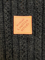 Orange Louis Vuitton patch on dark knit fabric reading 'MAKE LOVE, RESPECT'