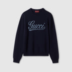 Gucci dark blue crewneck sweater with white script logo, long sleeves