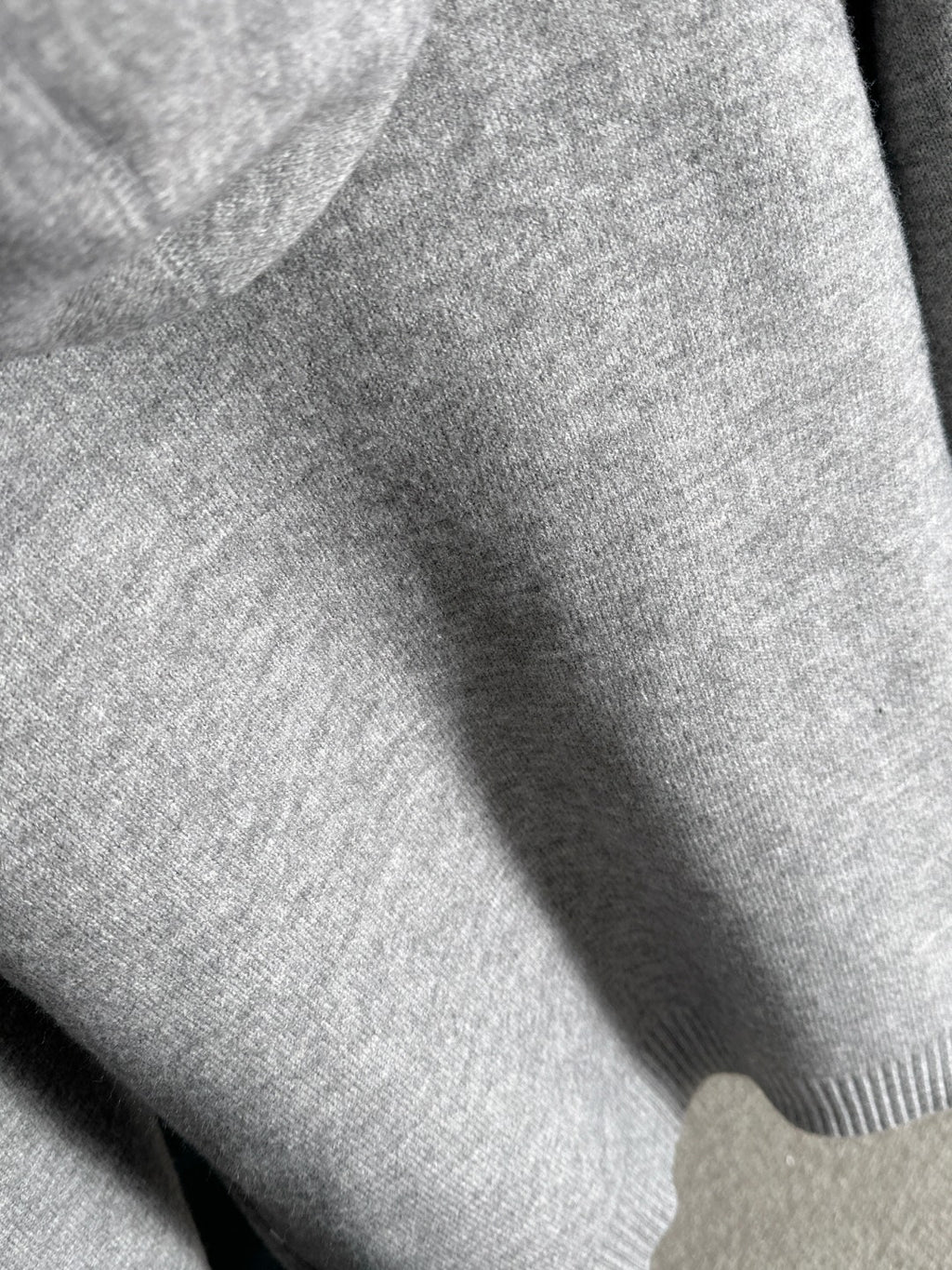 Dior long knit hoodie fabric close-up in heather gray with ribbed trim