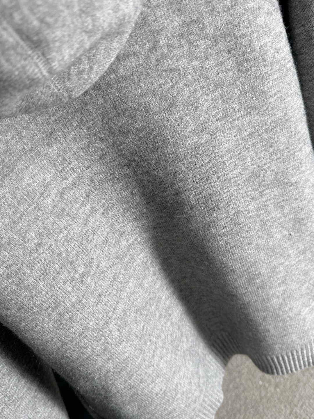 Dior long knit hoodie fabric close-up in heather gray with ribbed trim
