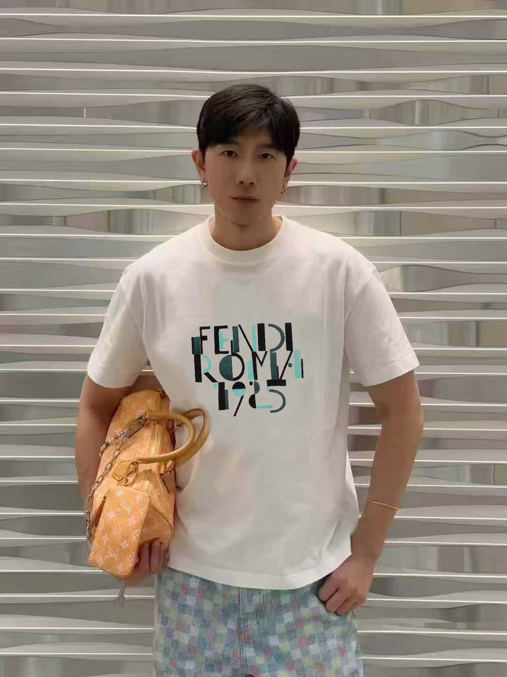 White Fendi short-sleeve T-shirt with Roma 1975 graphic, model posing