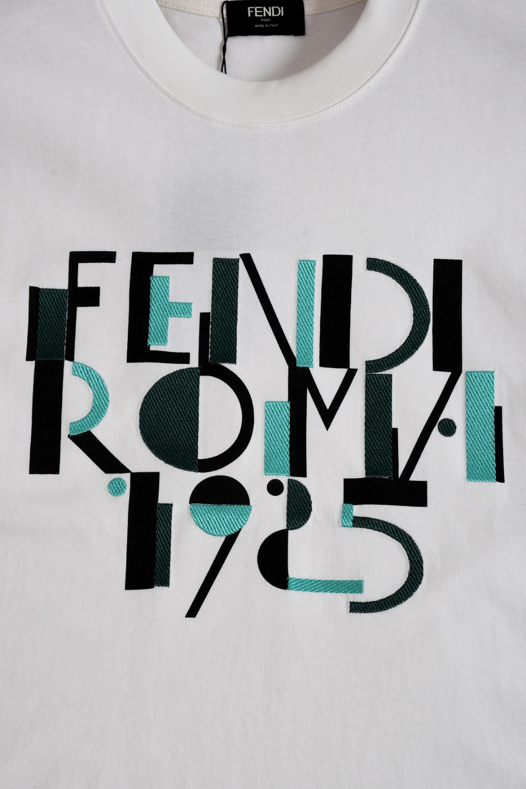 White Fendi T-shirt with large Roma 1975 typographic graphic in black and teal