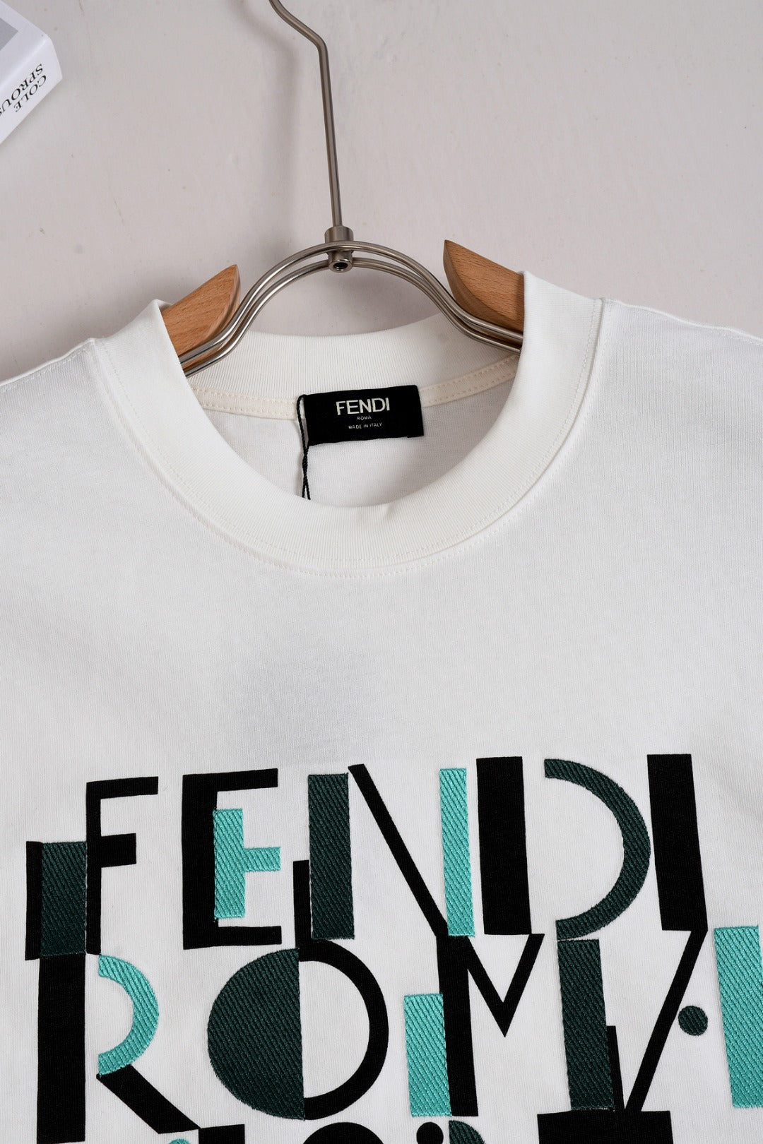 White Fendi T-shirt neckline with FENDI label and Roma 1975 graphic print