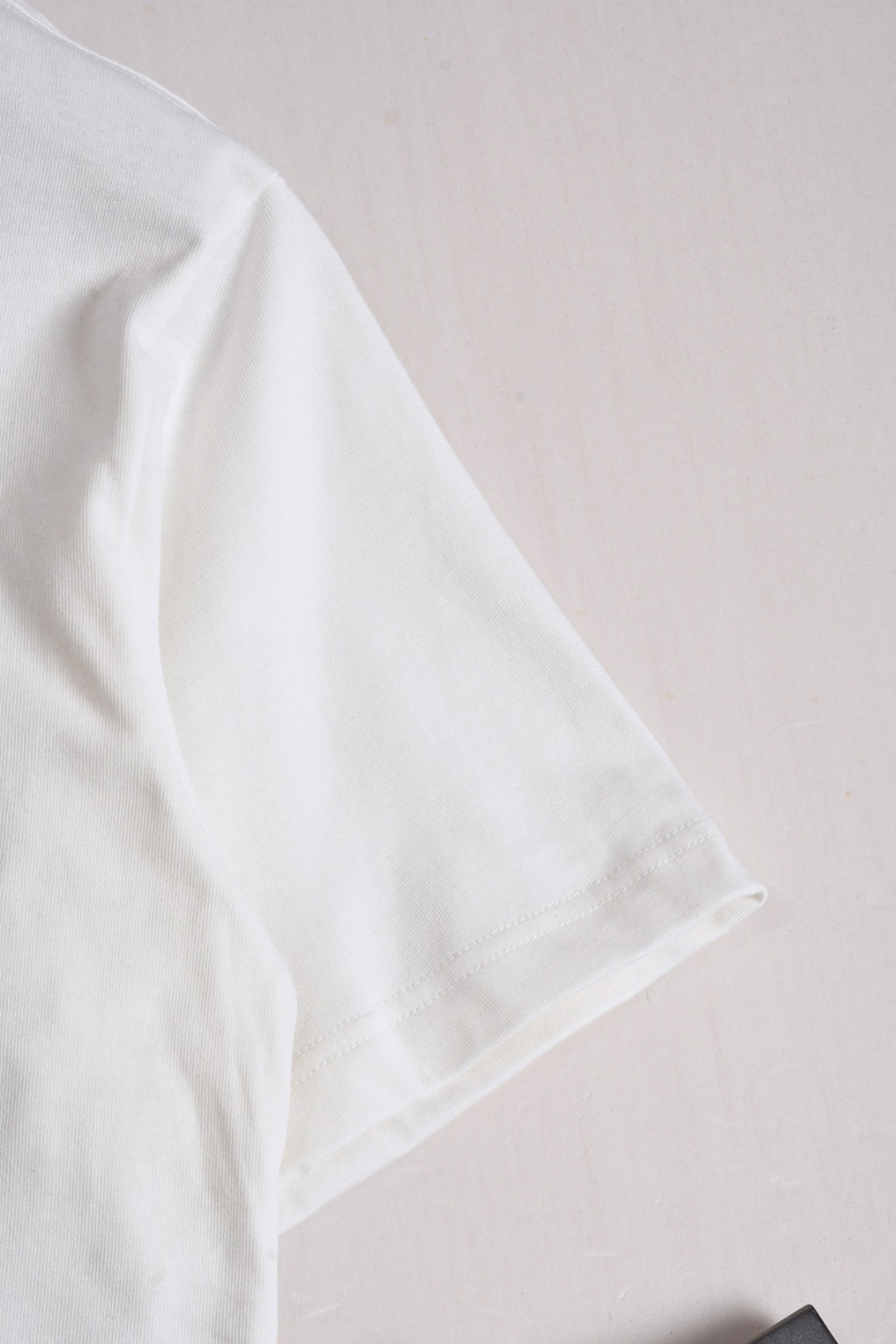 White Fendi short-sleeve T-shirt sleeve close-up, no visible print