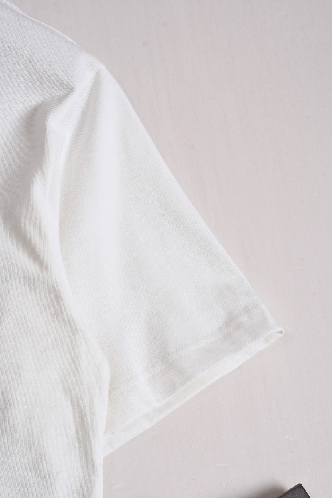 White Fendi short-sleeve T-shirt sleeve close-up, no visible print