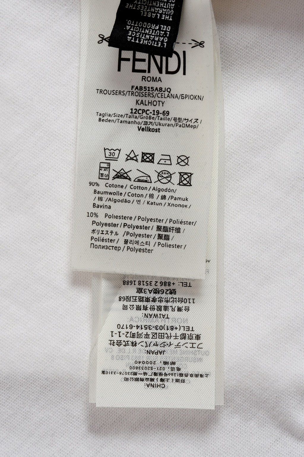 Fendi short care label tag on white fabric