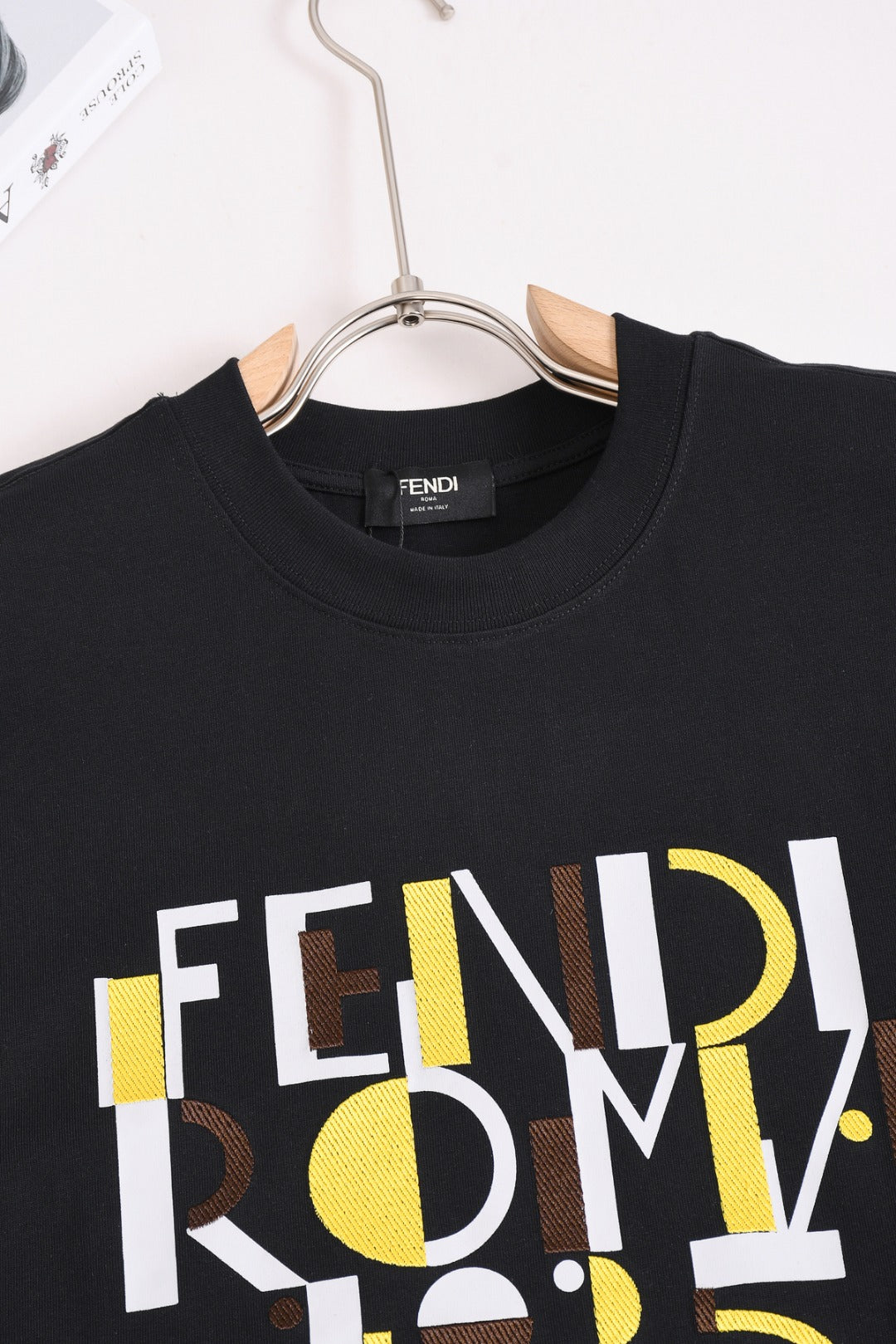 Fendi black short-sleeve T-shirt close-up of crew neck and FENDI ROMA 1975 logo