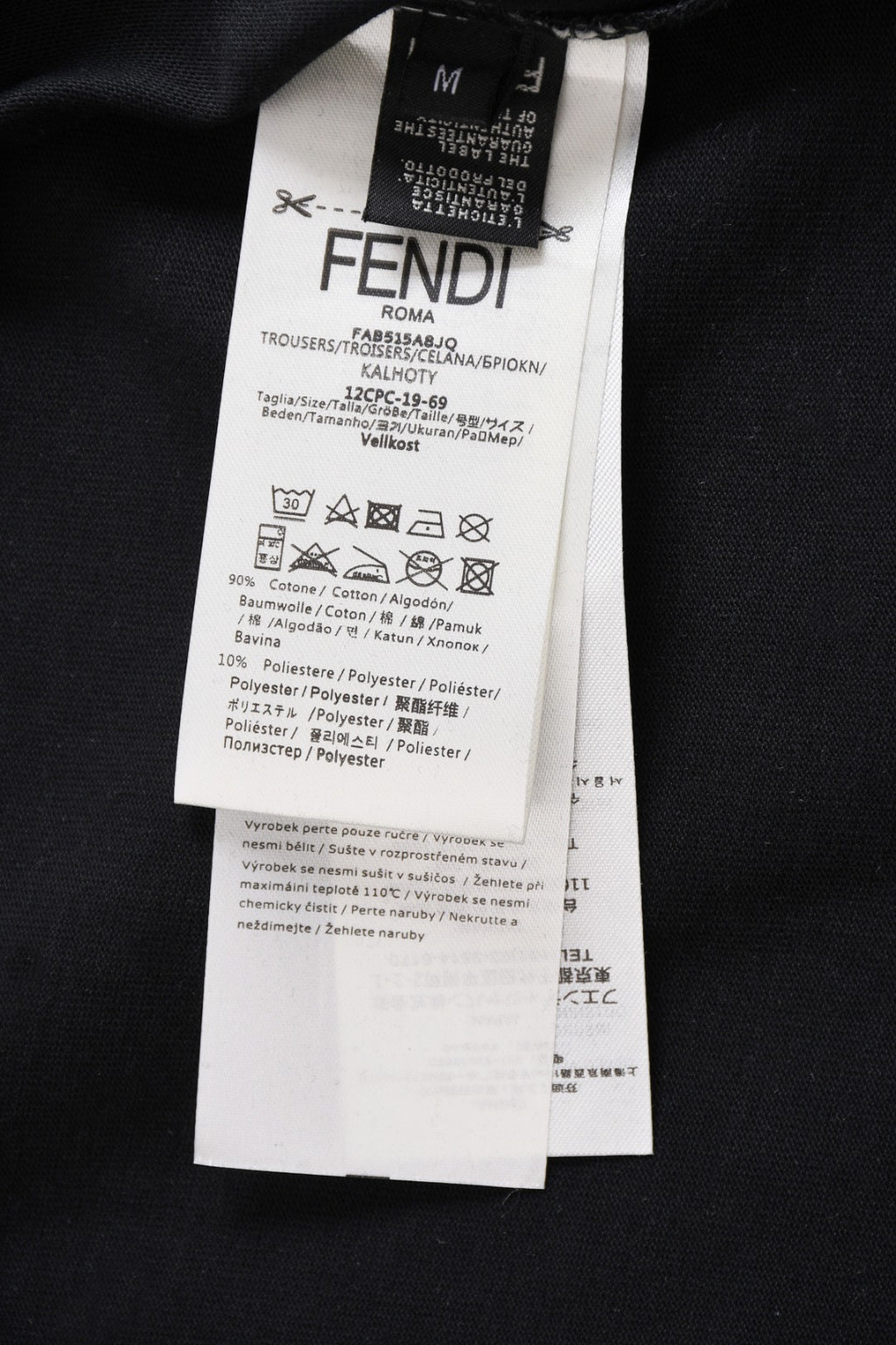 Fendi clothing label on dark top