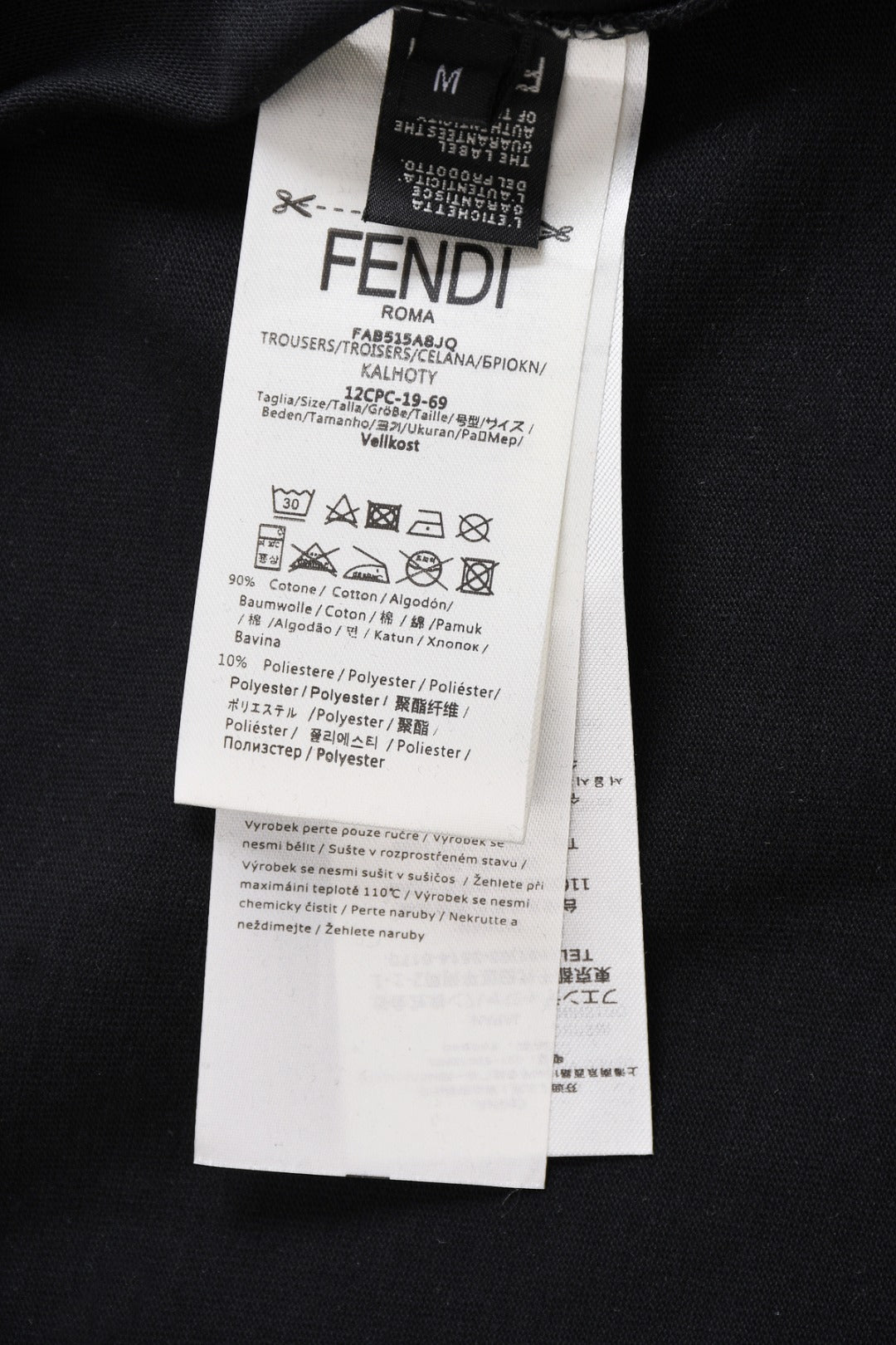 Fendi clothing label on dark top