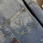 Denim jacket pocket close-up, embroidered pattern, yellow topstitch, button area