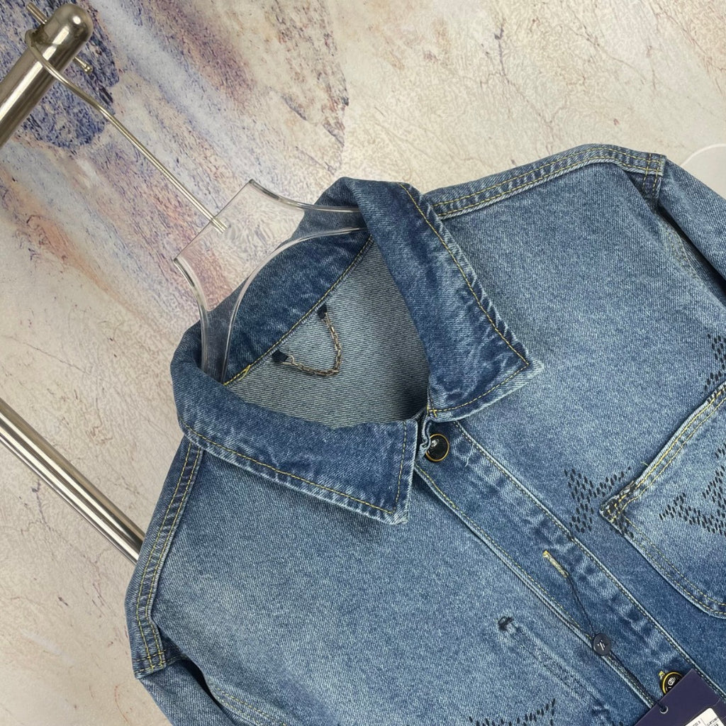 Denim jacket close-up, blue wash, chest pocket, seam details, button area