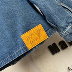 Denim jacket label patch, yellow tag on side seam with Louis Vuitton branding