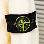 Black sleeve logo patch with yellow-green compass emblem