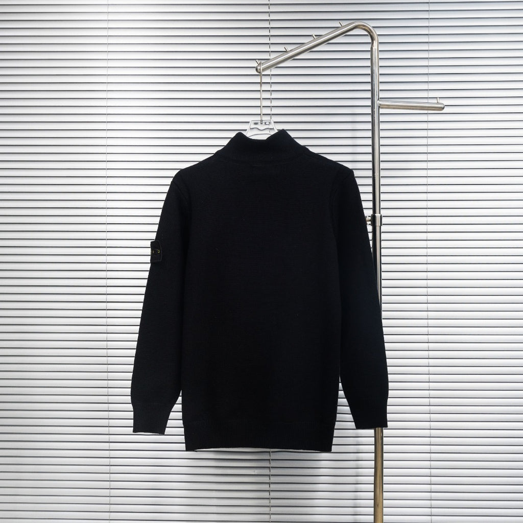 Black knit jacket back view with high collar on hanger