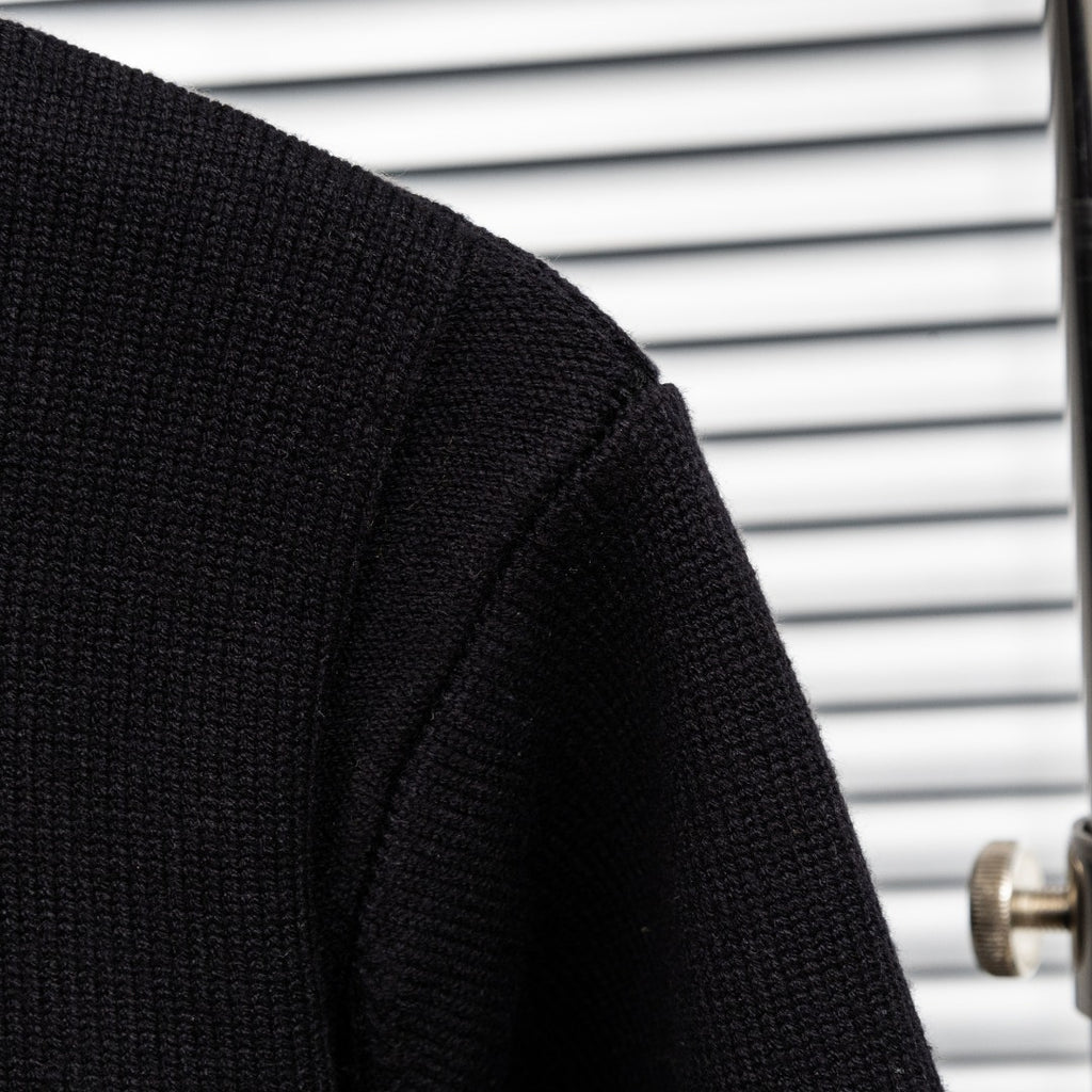 Black knit jacket sleeve with textured knit panel