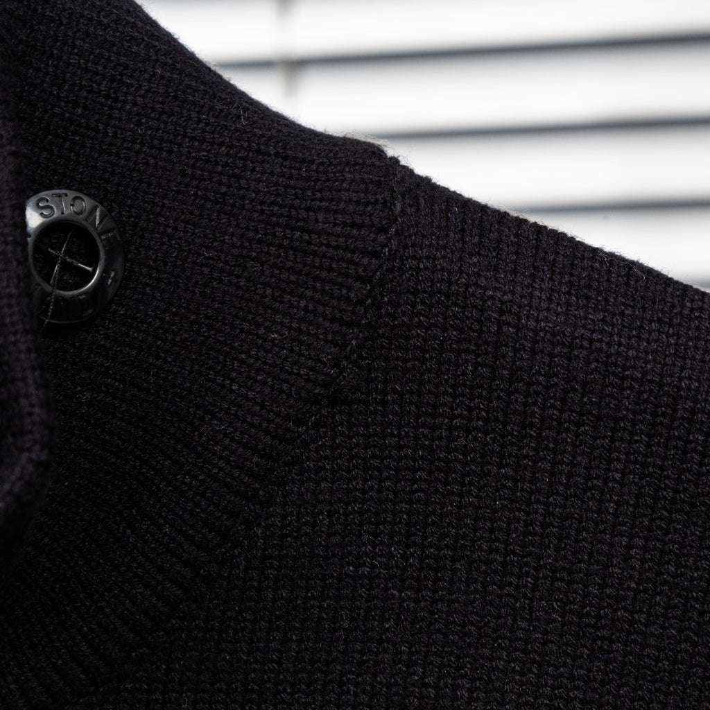 Black knit jacket shoulder with logo button detail