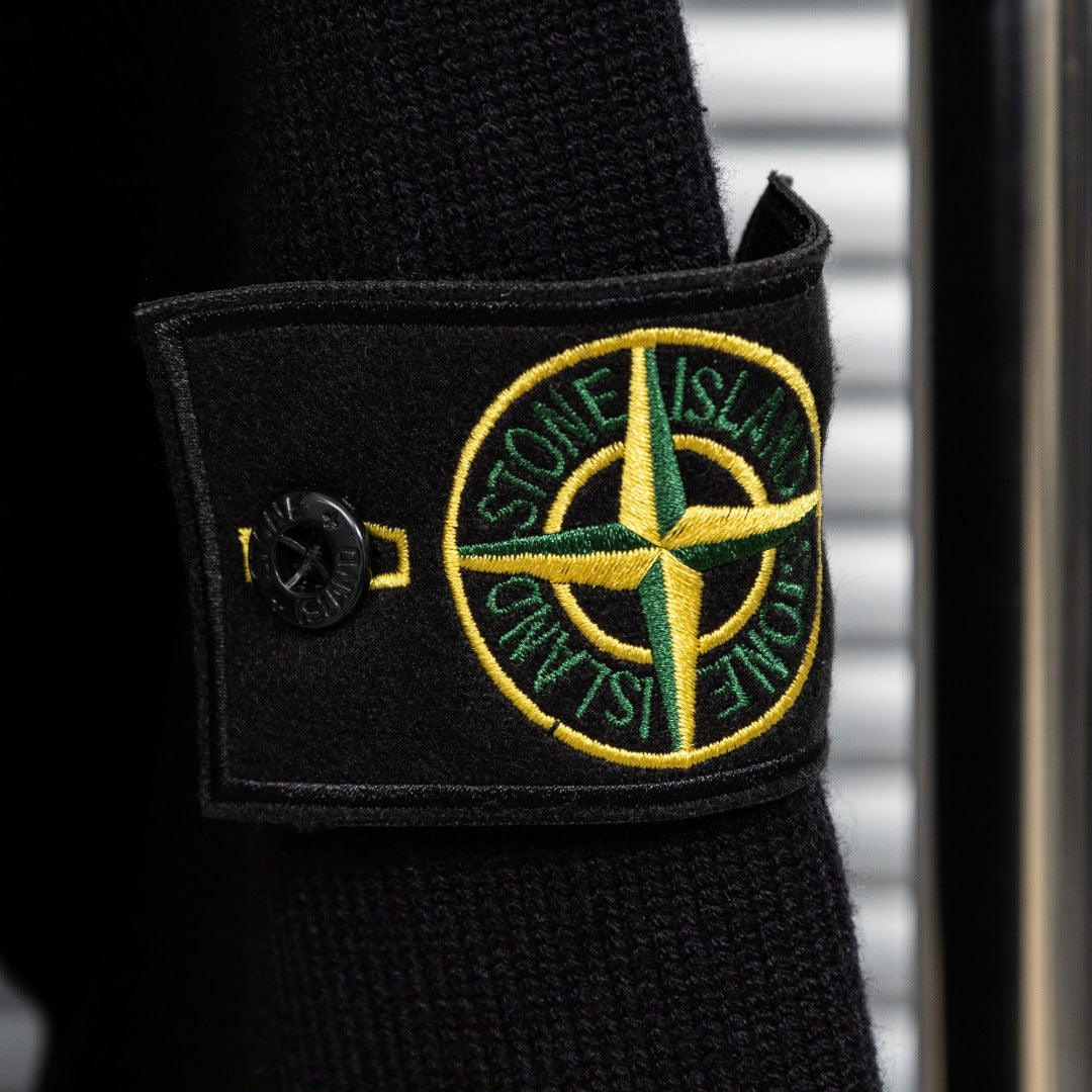 Black knit jacket cuff with embroidered Stone Island patch