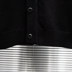 Black knit jacket front placket with dark buttons