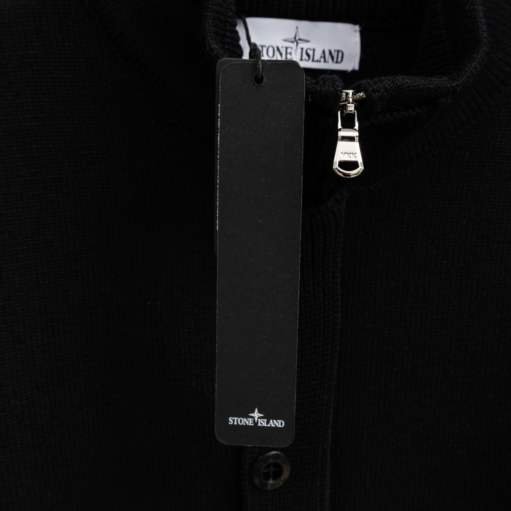 Black knit jacket with hanging tag and metal zipper pull