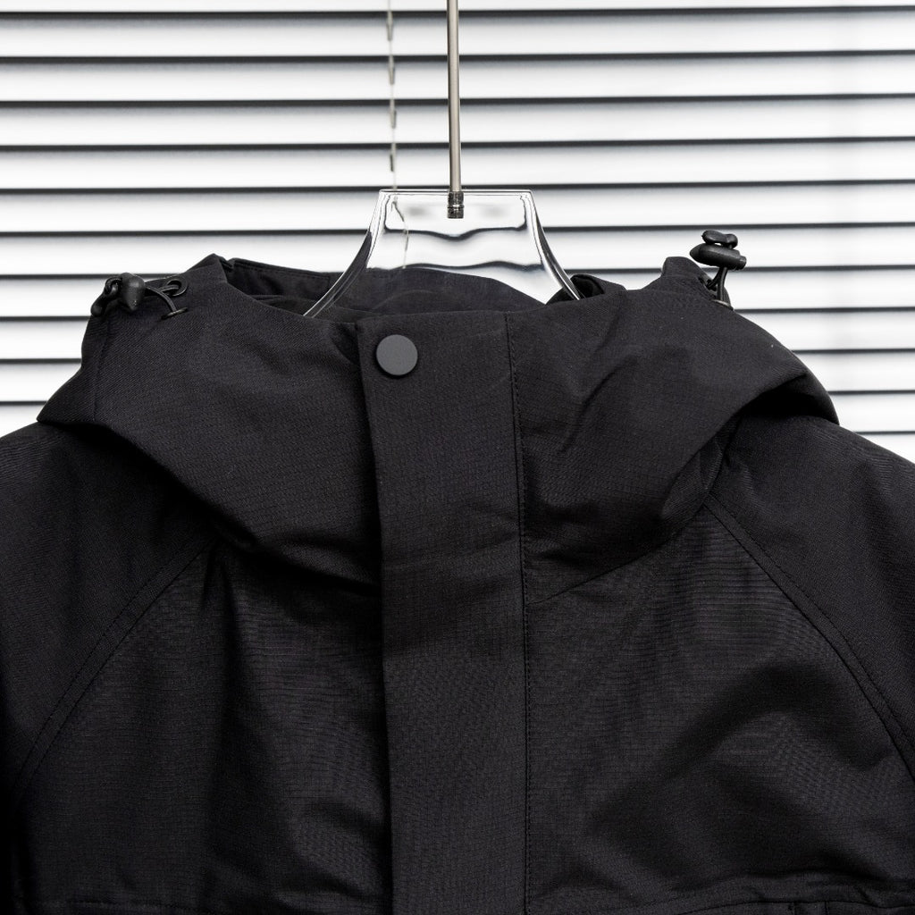 Stone Island hooded jacket close-up with front panel and snap button