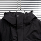 Stone Island hooded jacket close-up with front panel and snap button