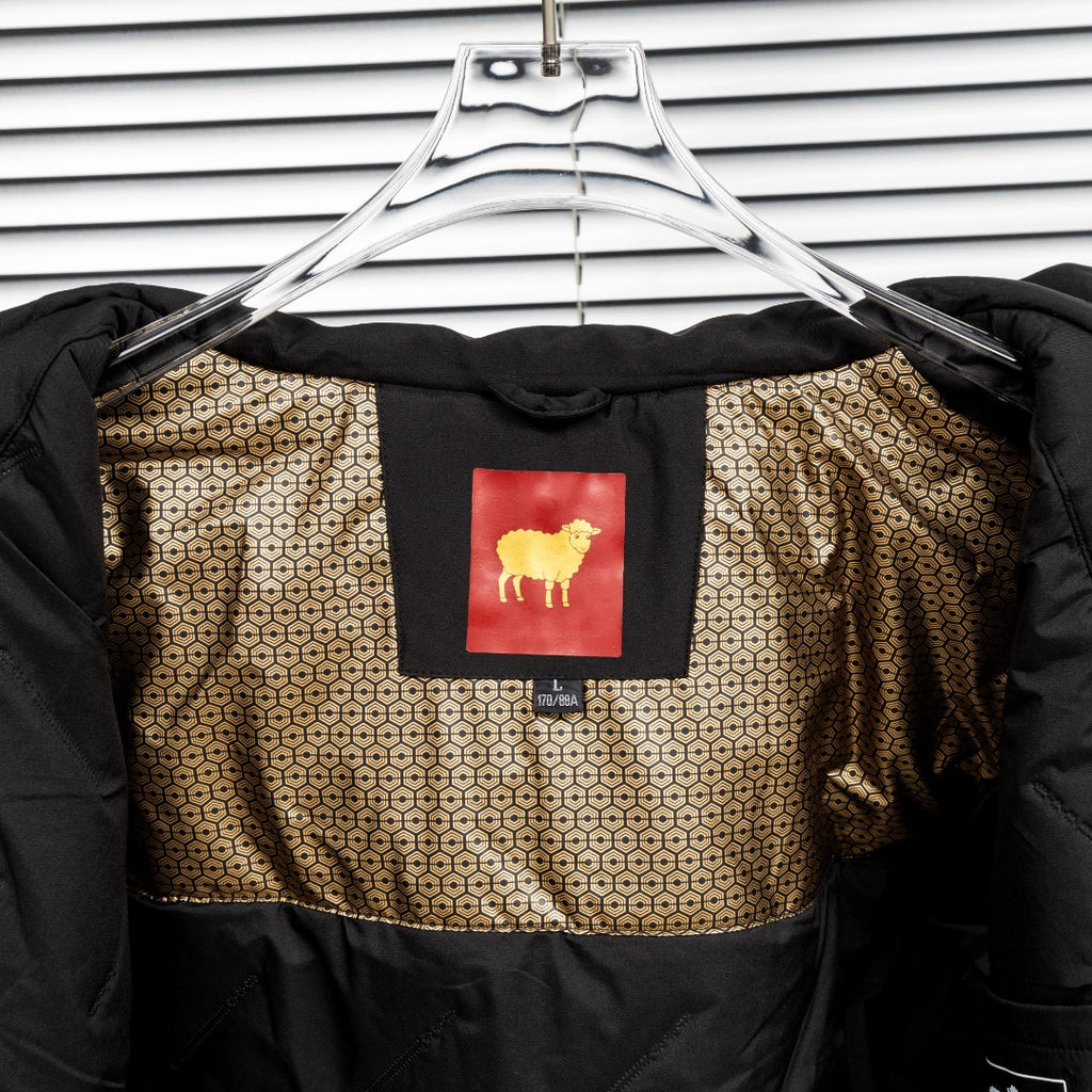 Stone Island black jacket lining with geometric pattern and gold sheep patch