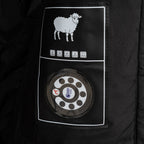 Stone Island jacket inner care label with sheep icon and thermostat graphic