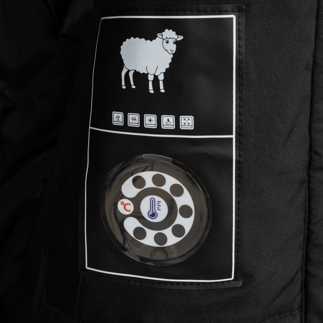 Stone Island jacket inner care label with sheep icon and thermostat graphic